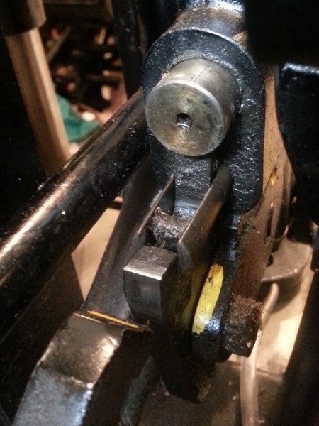 image: Plunger has the slot and crossbar to pull the pawl toward the operator. Trip lever is in the lower left corner of the image.