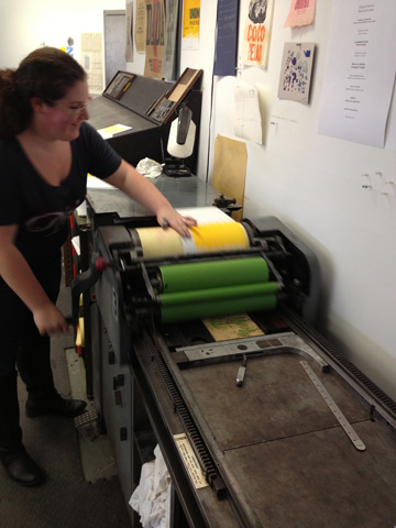 image: A student printing a run for her piece "Fruit Ninja" to be included in the Unwanted Outlaw portfolio.